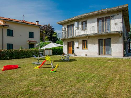 a yard with playground equipment in front of a house at Apartment More e Lamponi by Interhome in Avane