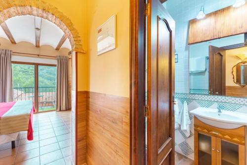 a bathroom with a sink and a mirror at Hotel Finca Fabiola in Finestrat