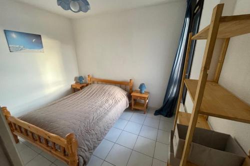 a bedroom with a bunk bed and a staircase at Charming Apt With Balcony In La Plagne Montalbert in La Plagne