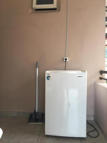 a white refrigerator in a room with a microwave at Guest House Roman/Gonio in Gonio