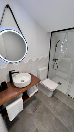 a bathroom with a sink and a toilet at Calma Suites Tejeda in Tejeda