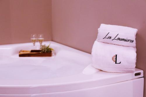 a towel sitting on top of a toilet in a bathroom at B&B Les Lumières in Salerno