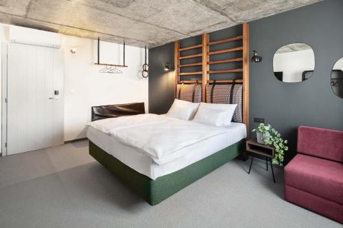Postel nebo postele na pokoji v ubytování Boutique Hotel Mezi švy