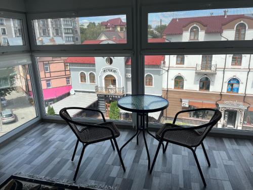 a table and two chairs in a room with a window at Апартаменти в центрі Трускавця in Truskavets