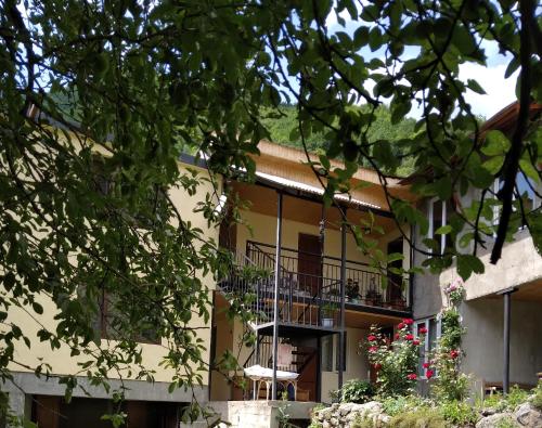 an external view of a building with a balcony at Lam Lha in Mestia
