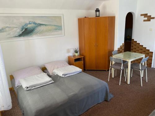 a bedroom with a bed and a table and a table and chairs at Eko Dolina Kluki in Kluki
