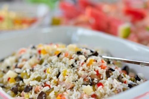 a dish of rice and vegetables with a knife at Hotel Bel Sit in Comano Terme