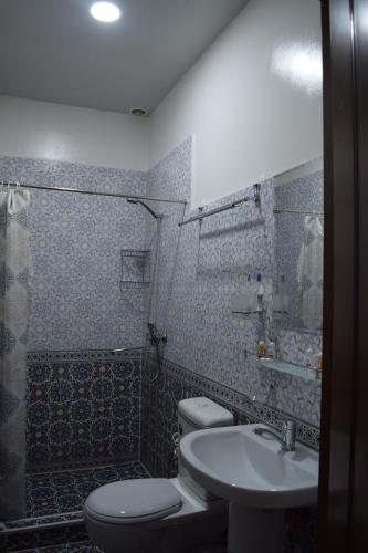 a bathroom with a toilet and a sink at Hotel SUZUK-OTA in Tashkent