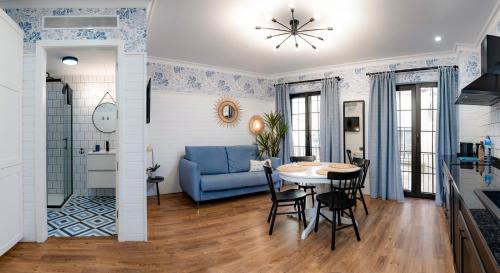 a living room with a blue couch and a table at "Breeze" Aparthotel by Parrot`s House in Lloret de Mar