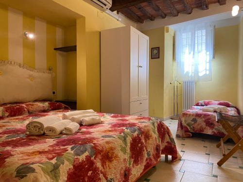 a bedroom with two beds and a window at Gaia's Apartment in Pistoia