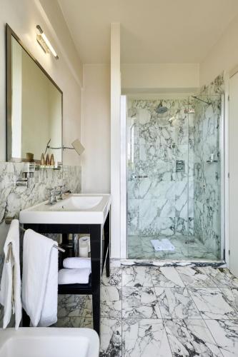 a bathroom with a sink and a shower at Mondial Resort & Spa in Marina di Pietrasanta
