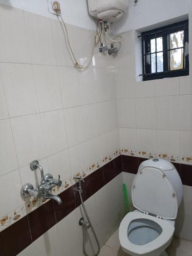 a bathroom with a toilet and a shower at Safa Serviced Apartments in Cochin