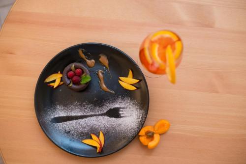 a plate of food with fruit on a table at Seva Hotel Health Club in Campina