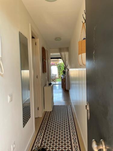 a hallway with a tile floor in a house at Beach flat with garden in Castelldefels