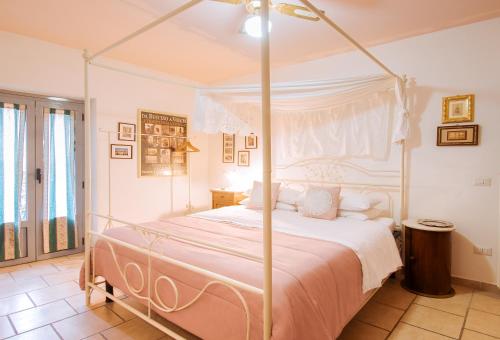 a bedroom with a bed with a canopy at La Fabbrica dell'Oro in Asti