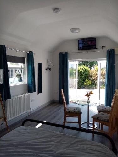 a bedroom with a bed and a table and a window at Up on the hill in Kinawley