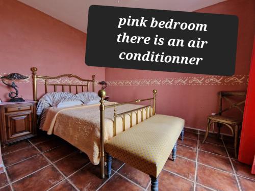 a bedroom with a bed and a chair with the words pink bedroom there is at Chambres d'hôtes Villa bella fiora in Biguglia