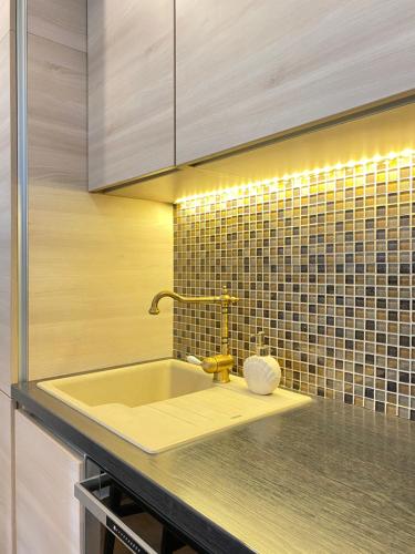 a kitchen sink with a faucet on a counter at Tower House Vodice in Vodice