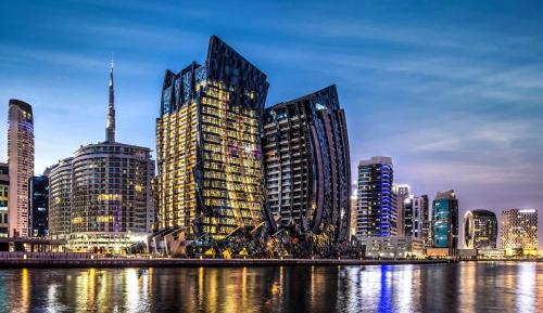 a city skyline with tall buildings next to the water at Unlock J One Downtown Dubai in Dubai