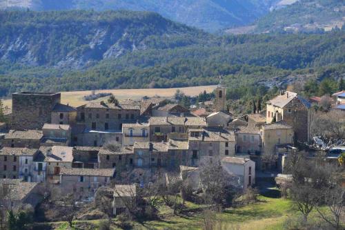 a village in the mountains with houses and trees at Château de Rosans in Rosans