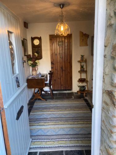 a hallway with a staircase with a wooden door at Bissick Old Mill in Truro