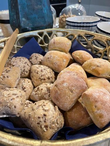a tray of breads and pastries on a table at 34 GuestHouse in Setúbal