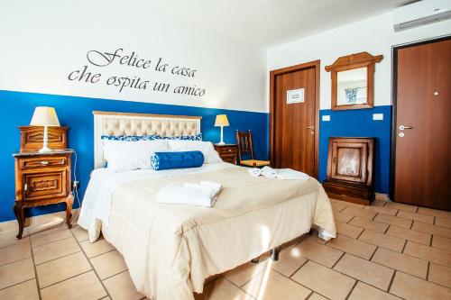 a bedroom with a bed with a sign on the wall at La Fabbrica dell'Oro in Asti