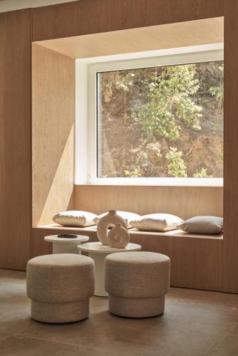 a room with two stools and a window at Radisson Resort Plaza Skiathos in Kanapitsa