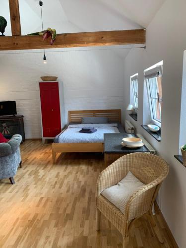 a bedroom with a bed and a table and a chair at Kleines Appartement in Sankt Augustin