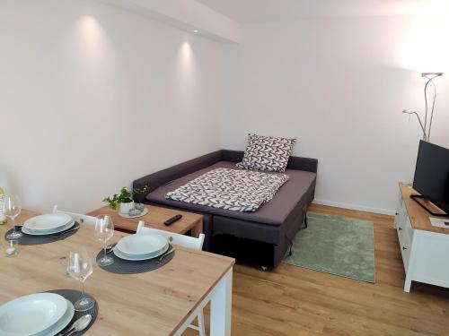 a living room with a couch and a table at FeWo Wildflecken - Ferienwohnung Rhön Neubau 2021 in Wildflecken