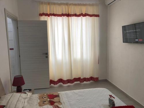 a bedroom with a bed and a large window at B&B Isola Mia in La Maddalena