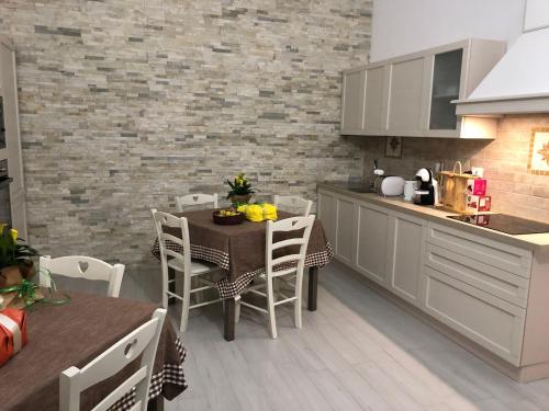 uma cozinha com uma mesa e cadeiras numa cozinha em B&B Isola Mia em La Maddalena