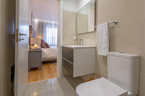 a white bathroom with a sink and a toilet at Casa de Sao Tiago 1 in Funchal