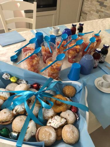 a table with two trays of cookies and other desserts at B&B Isola Mia in La Maddalena