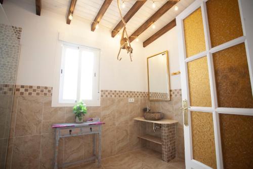 a bathroom with a shower with a mirror and a window at El Palacete de Cuevas in Cuevas del Almanzora