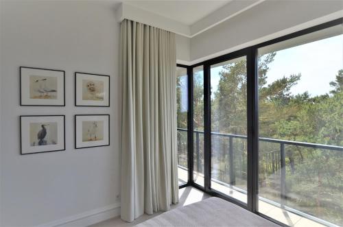 Ένα ή περισσότερα κρεβάτια σε δωμάτιο στο ApartamentyRogowo Com