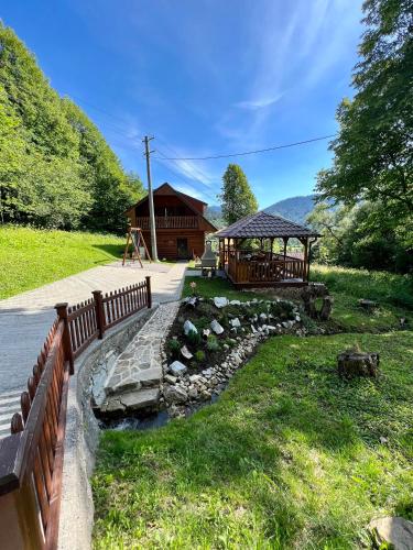 a house with a fence and a bridge and a river at Chata u Michala- neakceptujeme mladé partie in Terchová
