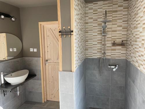 a bathroom with a sink and a shower at Pajda in Osieki Leborskie