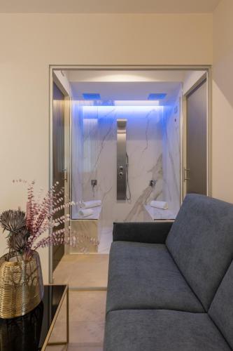 a living room with a couch and a glass wall at Giafra Luxury Rooms in Agrigento