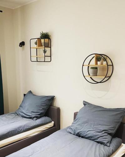 a bedroom with two beds and two mirrors on the wall at Gospodarstwo Agroturystyczne Zasadkowe Bory in Rogowo