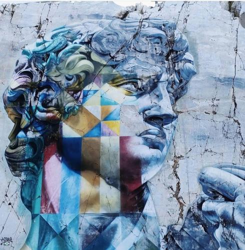 a painting of a face on a wall at Toscana Made in Love in Massa