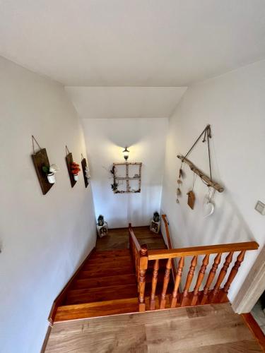 a staircase in a house with wooden floors and white walls at Chata u Michala- neakceptujeme mladé partie in Terchová