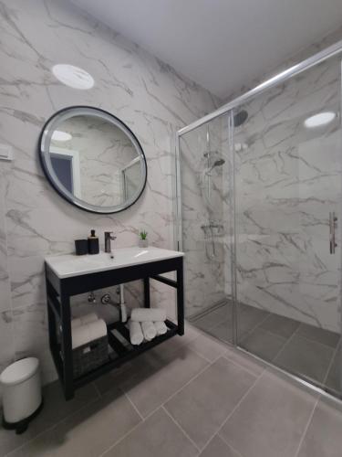 a bathroom with a sink and a shower with a mirror at Villa Madison in Posedarje