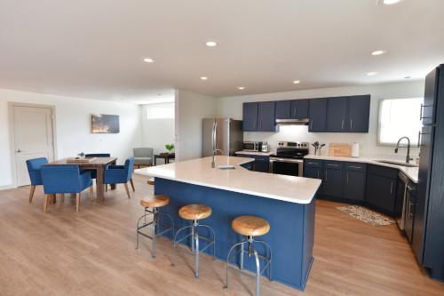 a kitchen with blue cabinets and a island with bar stools at Holiday Inn Express Wisconsin Dells by IHG in Wisconsin Dells
