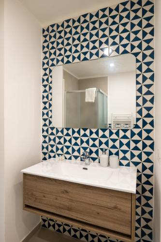 a bathroom with a sink and a mirror at Relais Vittorio Veneto - Luxotel & Apartotel in Salerno