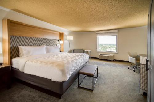a hotel room with a large bed and a window at Holiday Inn Mobile Downtown Historic District by IHG in Mobile