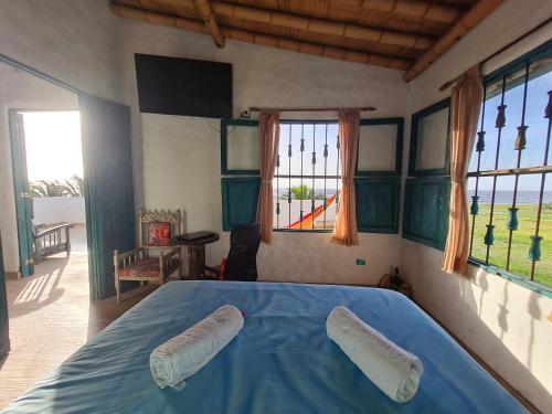 a bedroom with a blue bed with two pillows on it at SUITE CON TERRAZA PANORAMICA in Puebloviejo