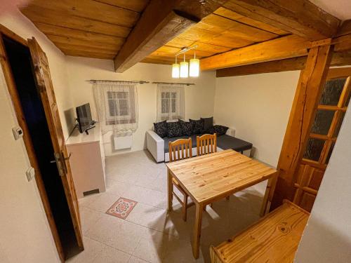 a living room with a table and a couch at Apartmány Penzion Koula in Pec pod Sněžkou