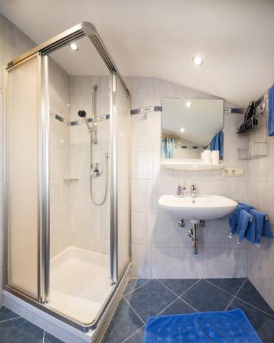 a bathroom with a shower and a sink at Pension Zum wilden Hannes in Wagrain