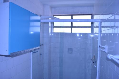 a bathroom with a shower and a window at Apartamento Bosque Águas de Lindóia in Águas de Lindoia